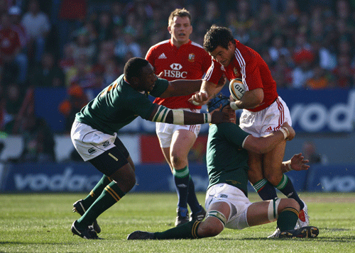 Lions scrum-half Mike Phillips is tackled by South Africa flanker Juan Smith 