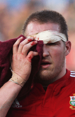 Lions prop Gethin Jenkins holds his eye after a collision