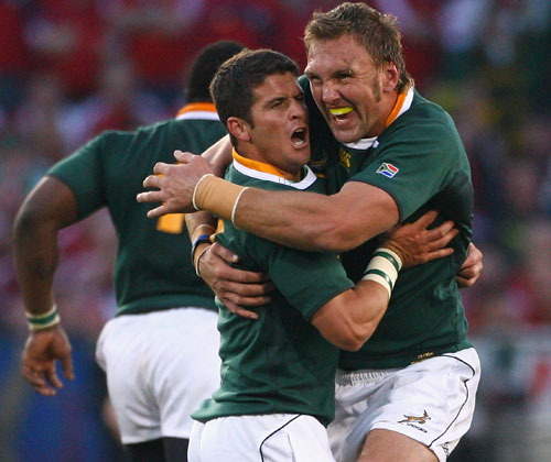 Morne Sten and Andries Bekker celebrate after Steyn kicks the winning penalty to beat the Lions
