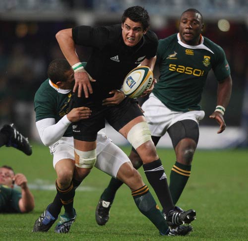 New Zealand lock Isaac Ross is tackled by South Africa's Bryan Habana in Durban