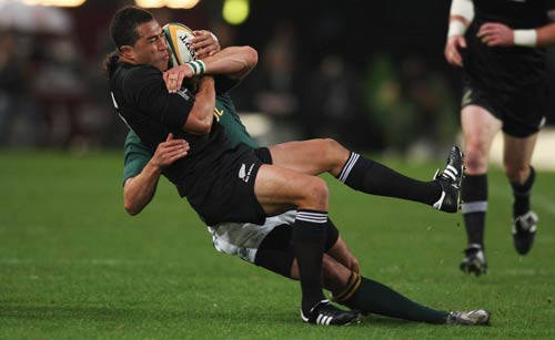 Mils Muliaina is wrapped up by Jaque Fourie in Durban