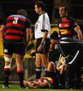 Canterbury's Dan Carter receives treatment after a late tackle