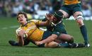 The Wallabies' Luke Burgess is grounded by South Africa's Heinrich Brussow in Cape Town