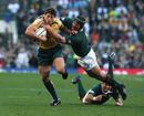 The Wallabies' Luke Burgess tries to shrug off a tackle from South African flanker Heinrich Brussow in Cape Town