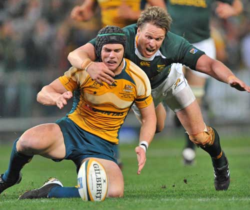 South Africa's Jean de Villiers tackles Australia's Berrick Barnes