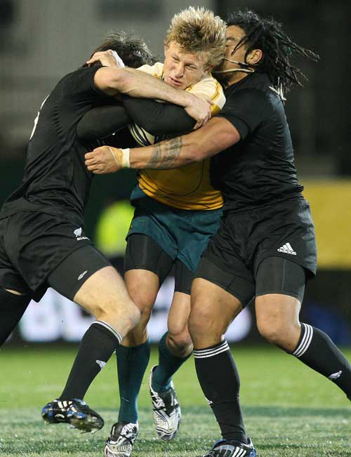 Australia's Lachie Turner is wrapped up by the New Zealand defence