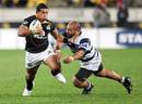 Wellington's David Smith is tackled by Auckland's Tevita Mailau