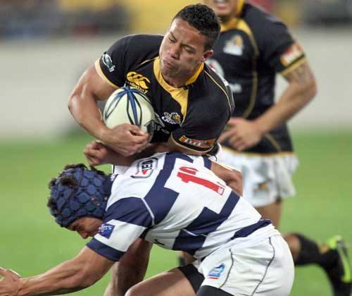 Wellington's Alapati Leuia is tackled by Auckland's Benson Stanley