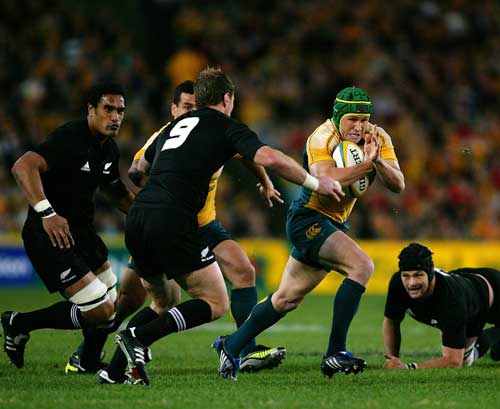 Australia fly-half Matt Giteau attacks a gap in the All Black defence