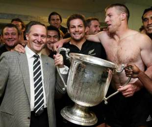 All Blacks skipper Richie McCaw is joined by Prime Minister John Key as they celebrate with the Bledisloe Cup, Australia v New Zealand, Tri-Nations, ANZ Stadium, Sydney, August 22, 2009