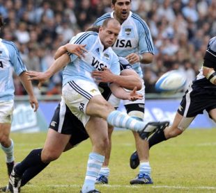 Argentine centre Felipe Contepomi (L) kicks the ball to the line tackled by a Scottish defender during the rugby union international test match between Argentina and Scotland at the Gigante de Arroyito stadium in Rosario, Santa Fe province, Argentina, on June 7, 2008. 