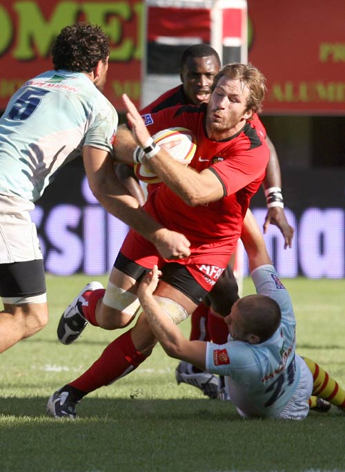 Toulouse lock Romain Millo-Chluski is tackled by Perpignan fly-half David Mele