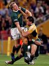 Australia's Adam Ashley-Cooper is tackled by South Africa's Jean de Villiers