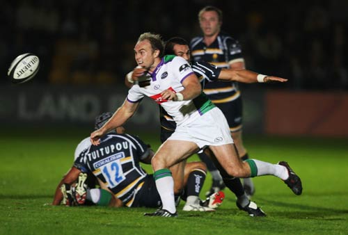 Leeds' Ceiron Thomas offloads jus as he is tackled by Willie Walker at Sixways