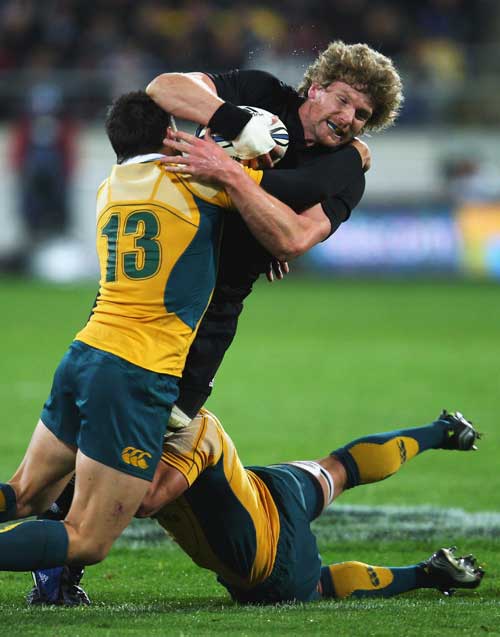 New Zealand flanker Adam Thomson is hit by Adam-Ashley Cooper