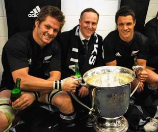 New Zealand's Richie McCaw and Dan Carter pose with Prime Minister John Key