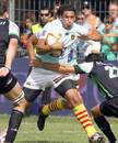 Perpignan's Maxime Mermoz is tackled by the Montauban defence