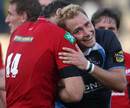 Glasgow fly-half Dan Parks embraces Scarlets wing Sean Lamont at the final whistle