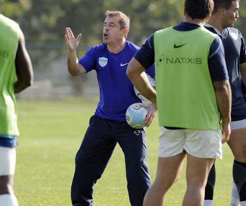 Racing Metro coach Pierre Berbizier instructs his players