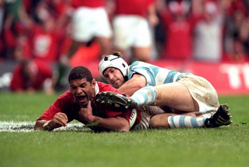 Wales' Colin Charvis of Wales scores the opening try in Cardiff