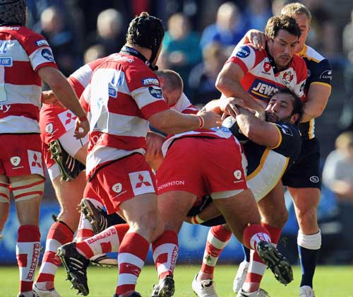 Leeds' Juan Gomez is tackled by the Gloucester defence