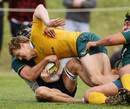 Australia's Ryan Cross is hauled down during a trial game