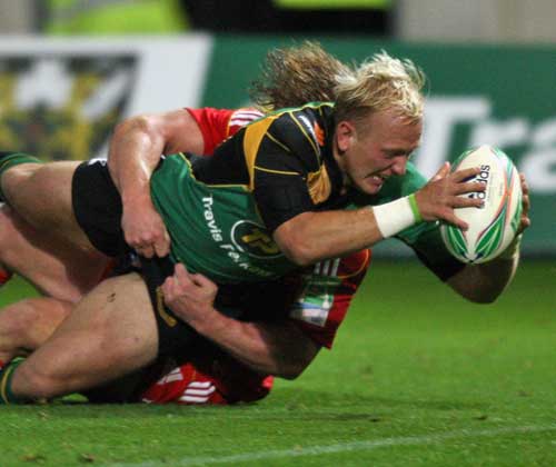 Northampton fly-half Shane Geraghty stretches to score a try