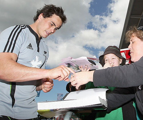 Zac Guildford signs autographs during an All Blacks autograph session