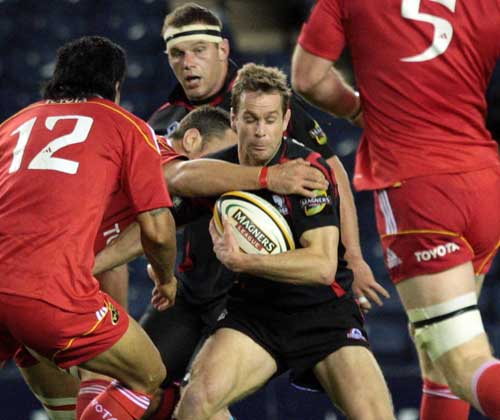 Edinburgh fullback Chris Paterson is swamped by the Munster defence