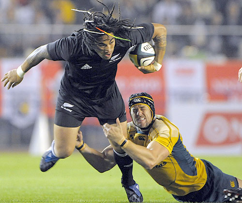 All Blacks centre Ma'a Nonu is tackled by Mark Chisholm 