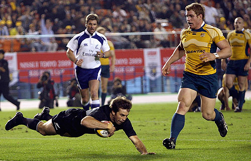 Conrad Smith of the All Blacks scores a try
