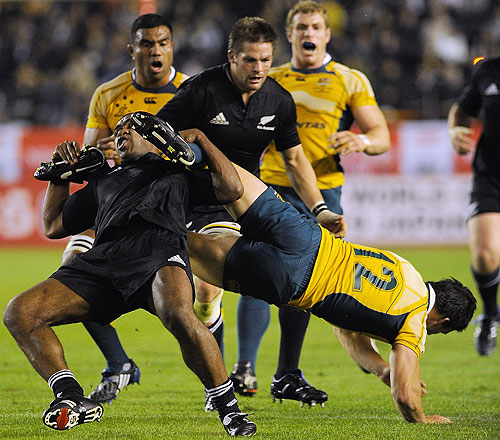 Sitiveni Sivivatu of the All Blacks makes an illegal tackle on Adam Ashley-Cooper