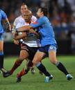 Cheetahs wing Lionel Mapoe is wrapped up by Francois Hougaard