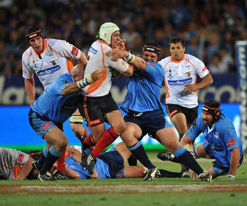 Cheetahs flanker Heinrich Brussow is held up by the Bulls defence