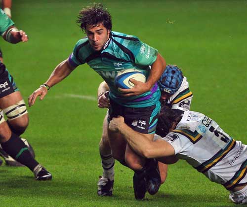 Ospreys fly half Gareth Owen is tackled by the Northampton defence