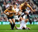 Australia wing Peter Hynes is hauled back by England's Danny Care