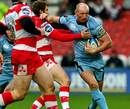 Cardiff Blues' Gareth Thomas fends off the Gloucester defence