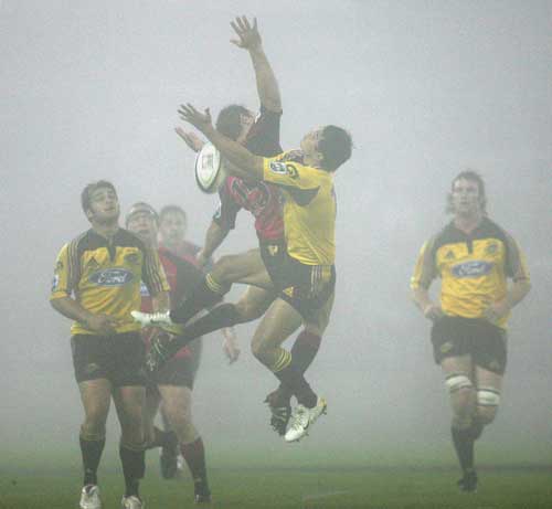 Leon MacDonald and Tamati Ellison compete for a high ball

