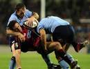Caleb Ralph is hit by the Waratahs defence