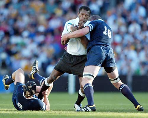 Fijian centre Epeli Ruivadra is tackled by the Scotland defence