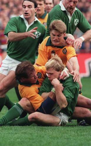 Ireland's Simon Geoghegan works hard to protect the ball under pressure from Australia's Simon Poidevin (L) and Tim Horan, Ireland v Austraila, Rugby World Cup 1991, Lansdowne Road, Dublin, Ireland, October 20, 2009