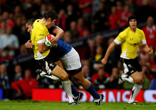 Wales fullback James Hook is levelled by Andy Tuilagi