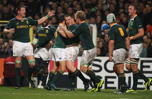 John Smit is congratulated after scoring the game's opening try against France