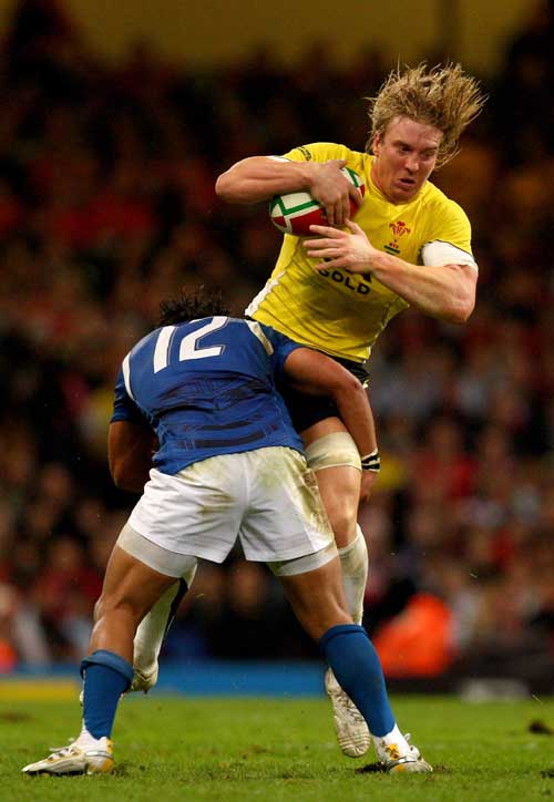 Andy Powell of Wales is tackled by Seilala Mapusua of Samoa at the Millennium Stadium