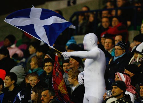 A bizarrely-attired Scotland fan gets behind his side