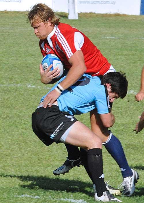 United States centre Paul Emerick is tackled by Uruguay's Joaquin Pastore