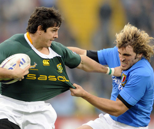 South Africa's Jaque Fourie is tackled by Italy's Mirco Bergamasco