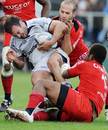 Castres hooker Mathieu Bonello istackled by Toulouse centre Maleli Kunavore