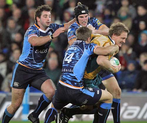 Australia's Ryan Cross is tackled by the Cardiff Blues defence