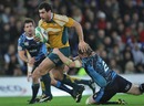 Australia's George Smith is tackled by the Blues' T Rhys Thomas